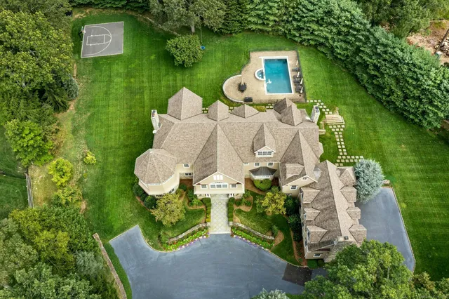an aerial view of a house with garden space seating area and yard