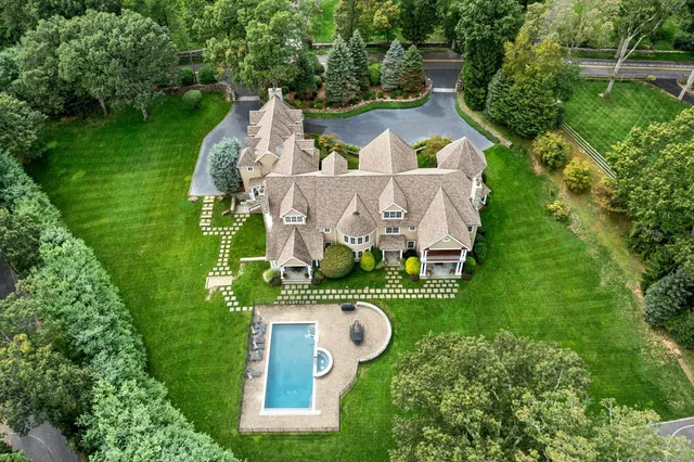 an aerial view of a house with outdoor space pool seating area and yard