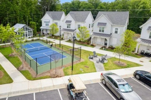 a view of a house with pool and chairs