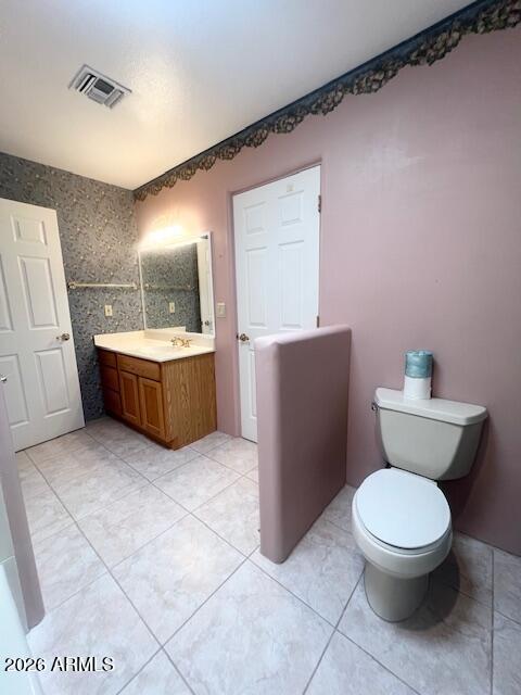 7707 East Primrose Path Carefree, AZ 85377 - Photo 12 of 42 a bathroom with a toilet a sink and mirror