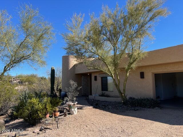 7707 East Primrose Path Carefree, AZ 85377 - Photo 29 of 42 a front view of a house with sitting area