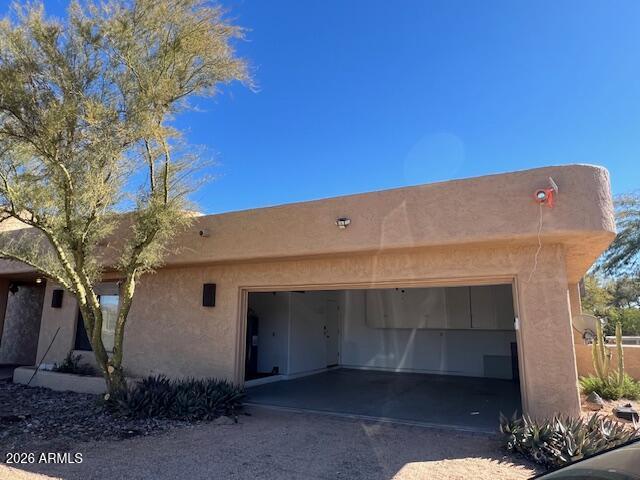 7707 East Primrose Path Carefree, AZ 85377 - Photo 33 of 42 a view of backyard with potted plants and large tree