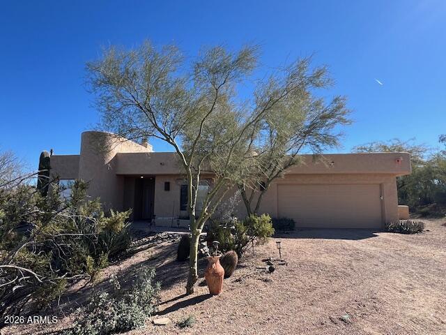 7707 East Primrose Path Carefree, AZ 85377 - Photo 36 of 42 a front view of a house with garden
