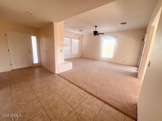 7707 East Primrose Path Carefree, AZ 85377 - Photo 10 of 42 en empty room with windows and fan