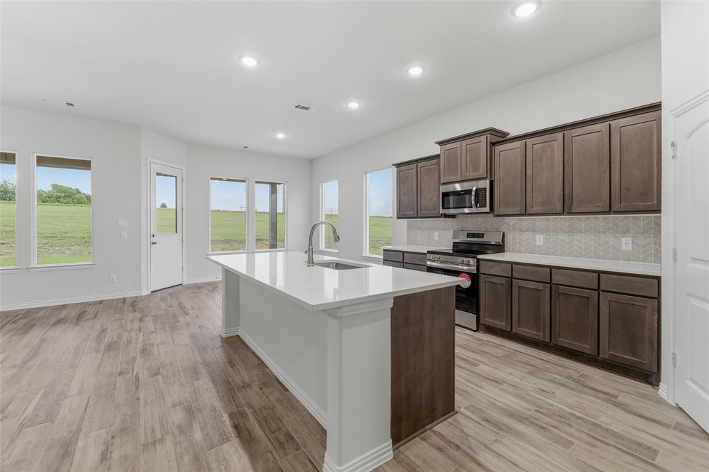 119 Hillview Trail Decatur, TX 76234 - Photo 19 of 30 Kitchen featuring a center island with sink, wood-finish flooring, recessed lighting, and ample cabinetry