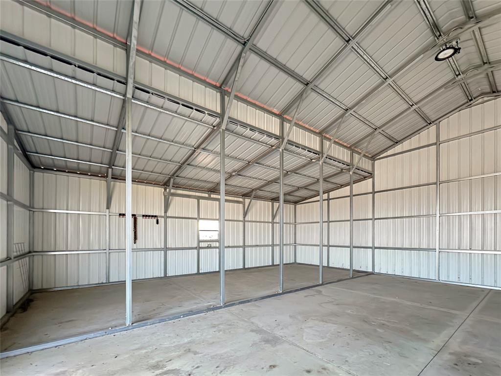 501 County Road 501 Blue Ridge, TX 75424 - Photo 11 of 27 Secondary interior angle highlighting the barn’s clean steel construction, overhead lighting, and adaptable space for stalls, storage, or work areas.