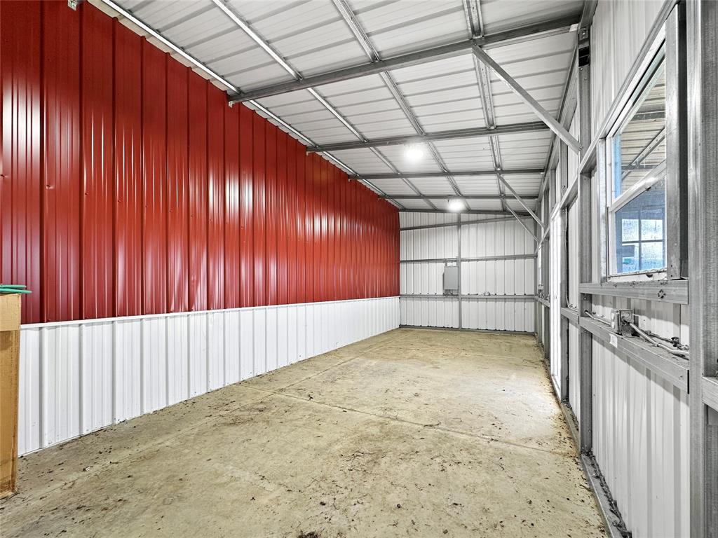 501 County Road 501 Blue Ridge, TX 75424 - Photo 15 of 27 Enclosed tack room with metal-paneled walls, concrete flooring, electrical access, and a secure door, suitable for organized equipment and supply storage.