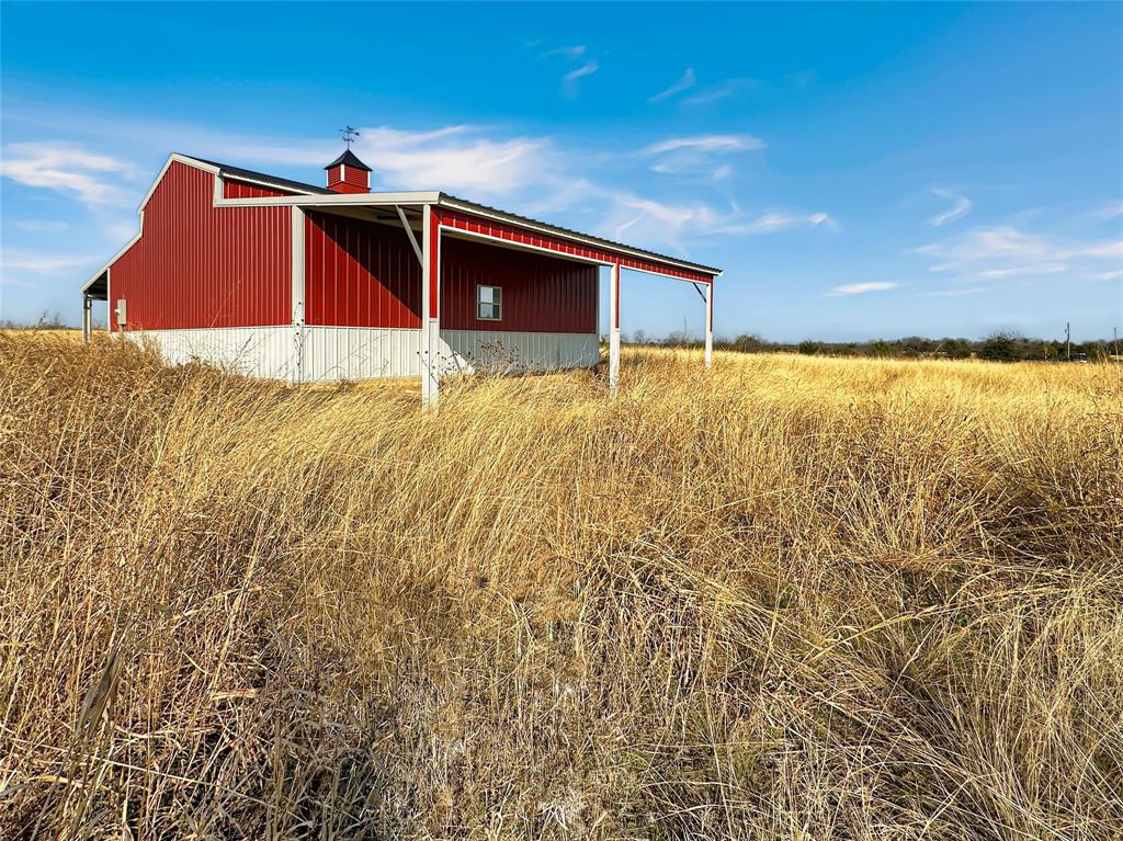 501 County Road 501 Blue Ridge, TX 75424 - Photo 4 of 27 Rear and side exterior perspective showing durable metal construction, wide clearance areas, and surrounding open land with unobstructed access.