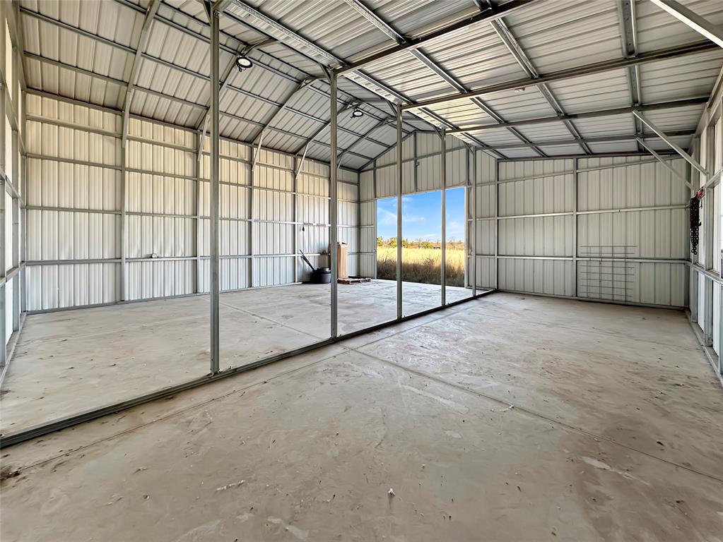 501 County Road 501 Blue Ridge, TX 75424 - Photo 10 of 27 Interior view showing smooth concrete slab flooring, wide open span design, and natural light from large entry openings.