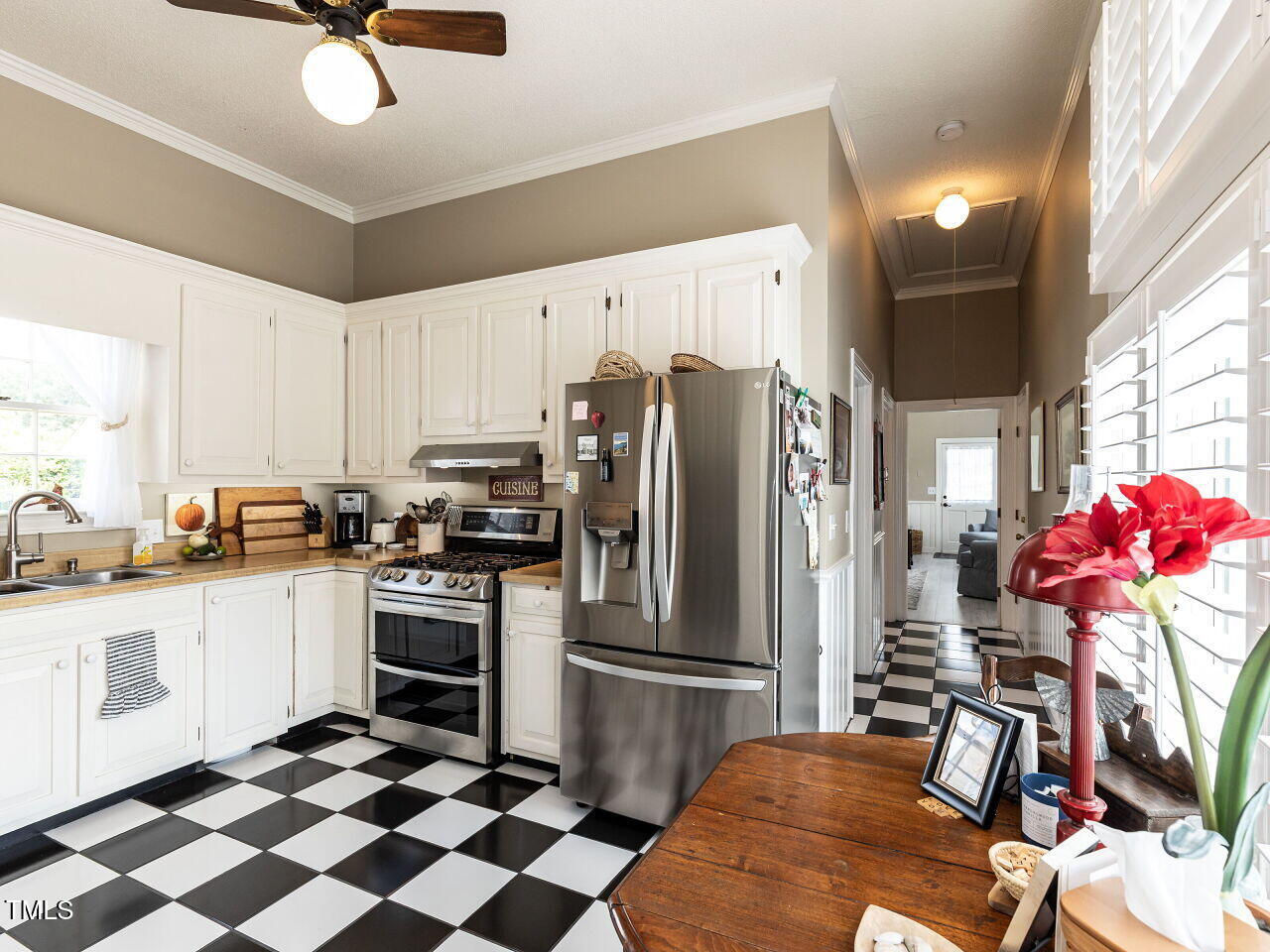612 College Street Clinton, NC 28328 - Photo 11 of 70 a kitchen with stainless steel appliances kitchen island granite countertop a refrigerator and a stove top oven