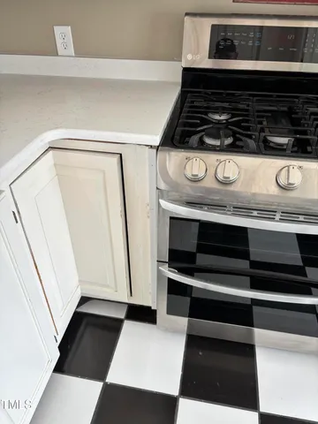 a bedroom with a bed dresser and a fireplace