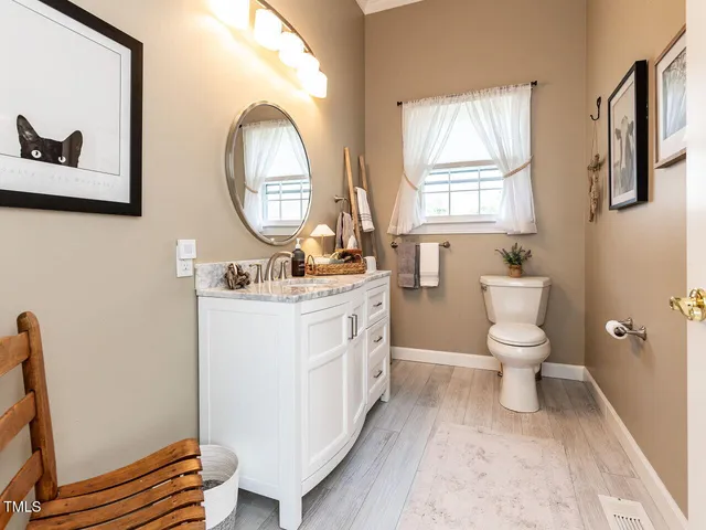 a front view of a house with sitting area and garden