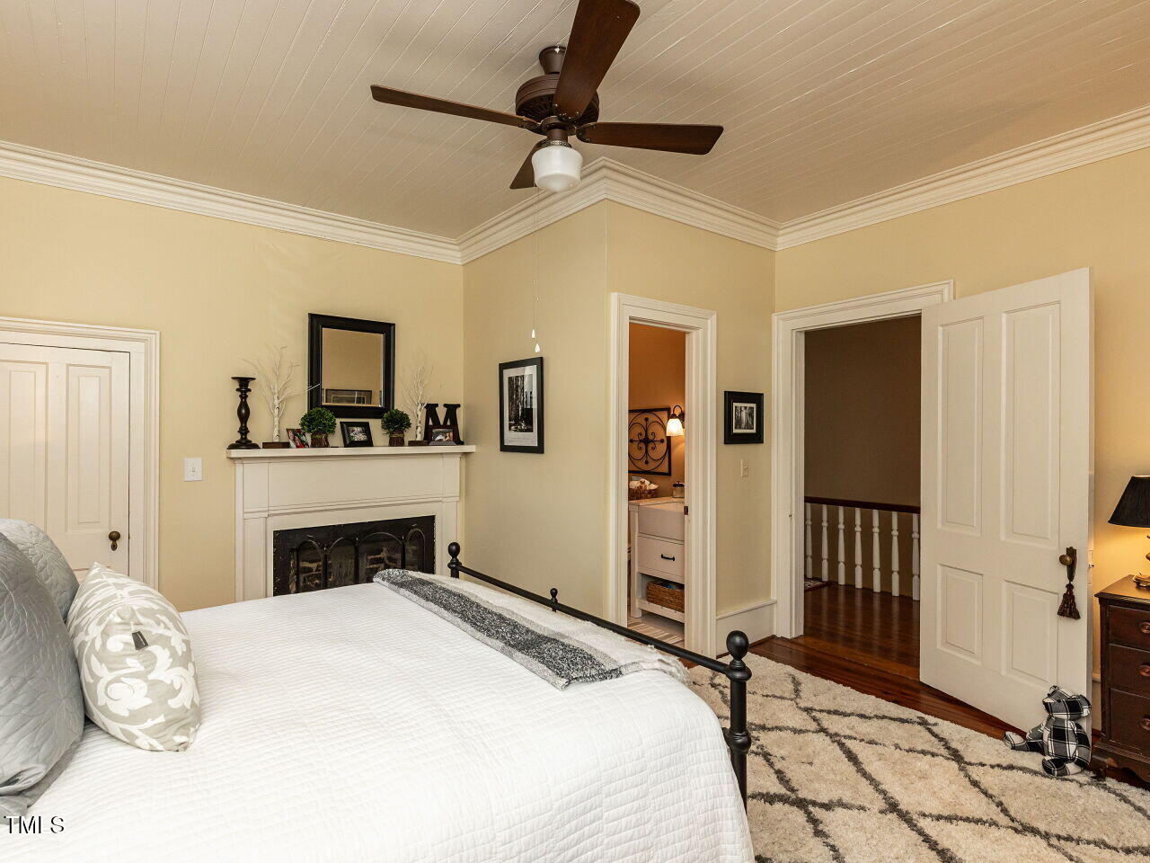 612 College Street Clinton, NC 28328 - Photo 29 of 70 a bedroom with a bed dresser and a fireplace