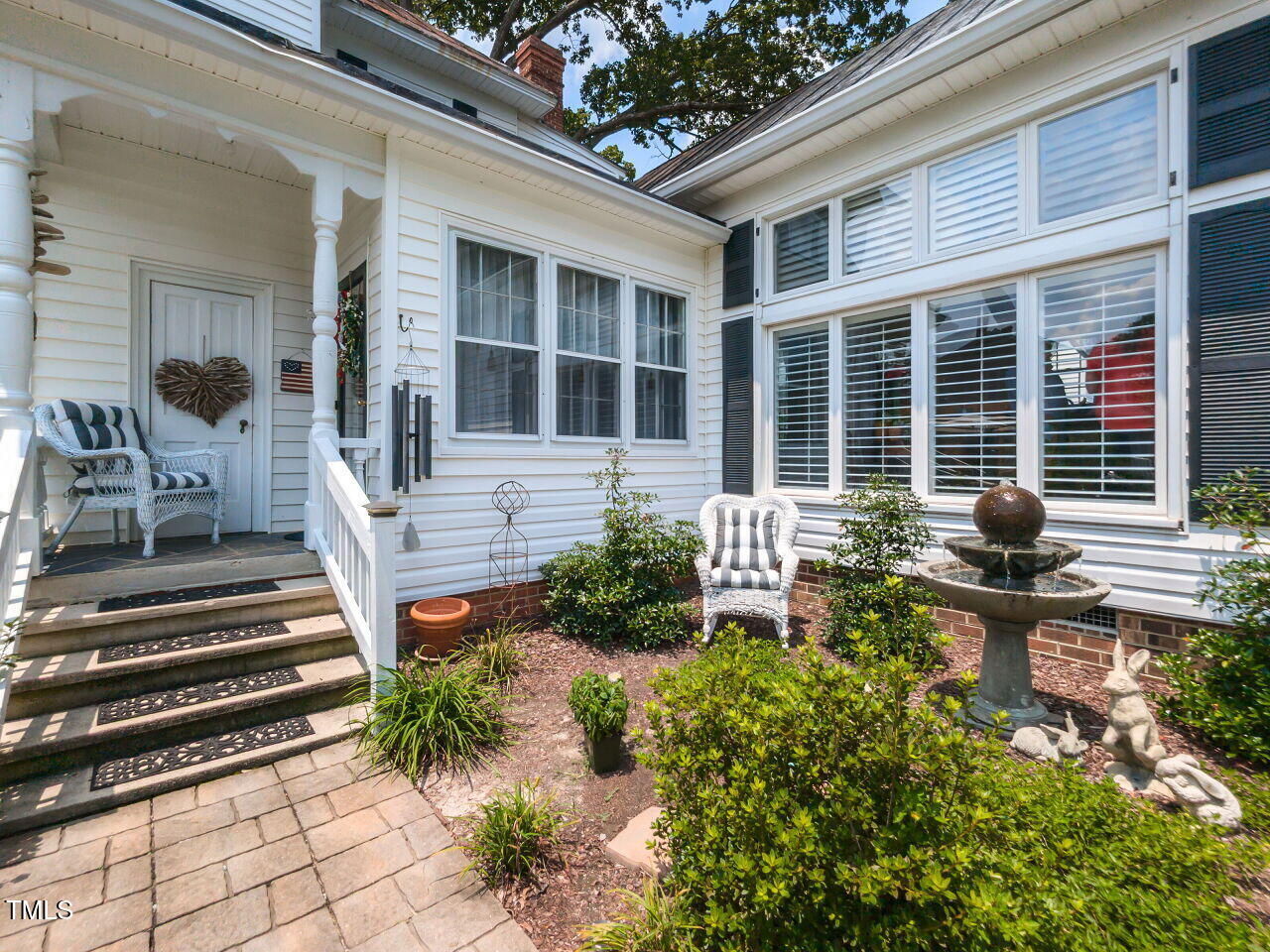612 College Street Clinton, NC 28328 - Photo 41 of 70 a front view of a house with sitting area and garden