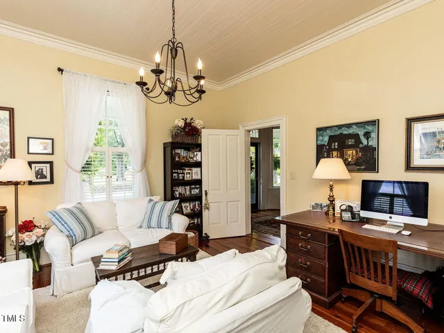 a living room with furniture ceiling fan and a window