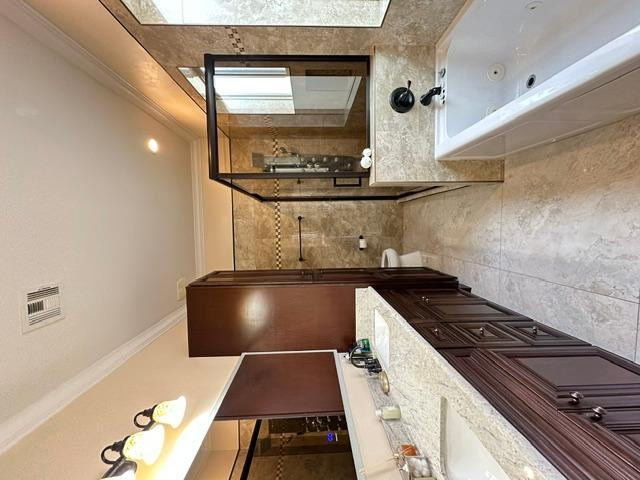 6830 North 14th Street Phoenix, AZ 85014 - Photo 17 of 28 a kitchen with a stove and a wooden floor