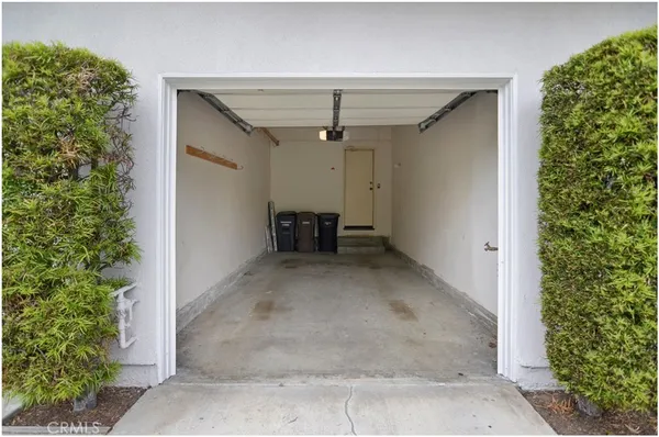 an empty room with windows and ceiling fan