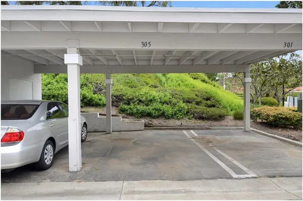 a white car parked in front of a building
