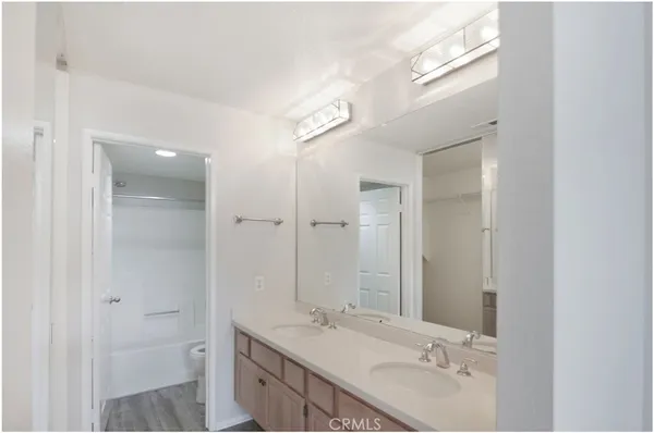 a bathroom with a double vanity sink and a mirror
