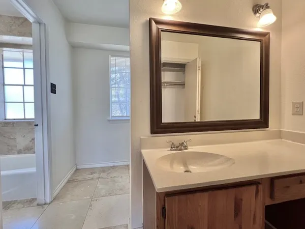 a bathroom with a sink a vanity and a mirror