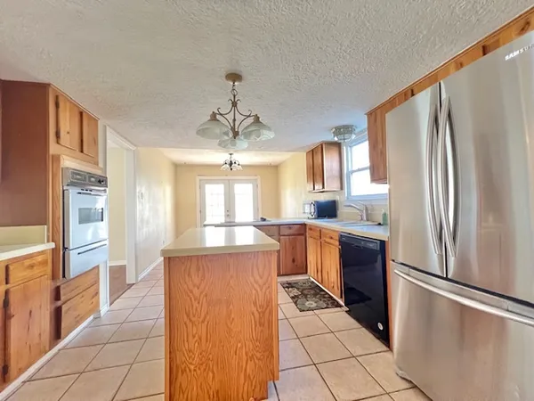 a kitchen with stainless steel appliances a refrigerator and a stove top oven