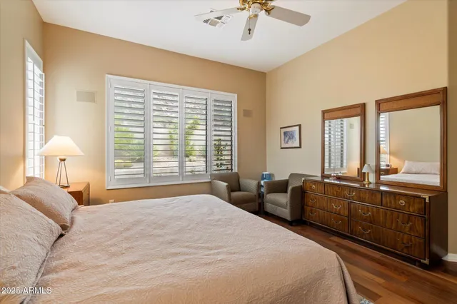 a bedroom with a large bed and a chandelier