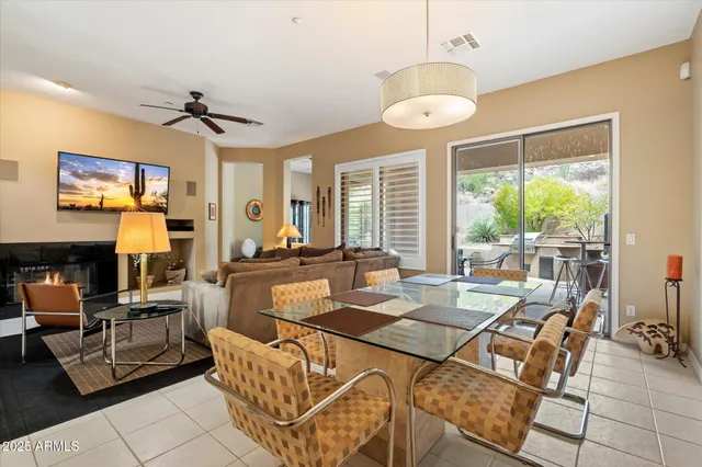 a living room with fireplace furniture and a large window