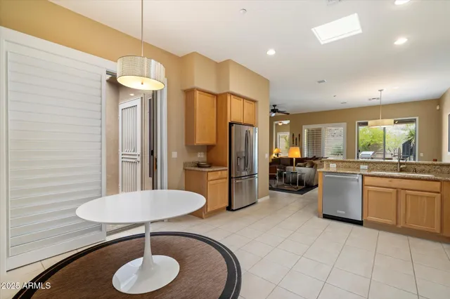 a kitchen with a refrigerator a sink dishwasher a stove and a refrigerator with wooden floor