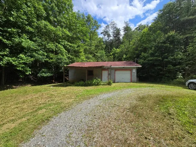 a front view of house with yard and trees
