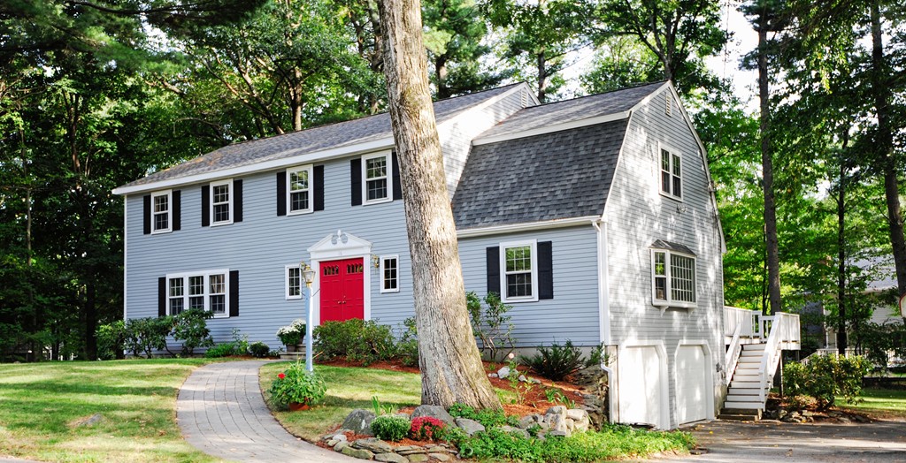 a front view of a house with garden