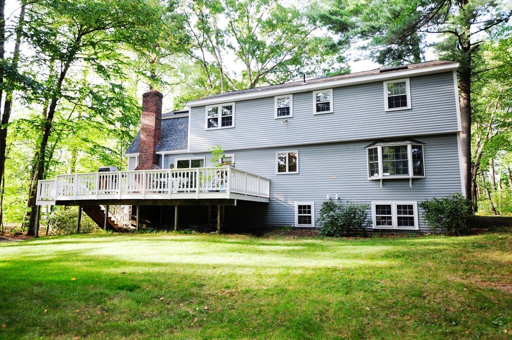 16 Olde Lantern Road Acton, MA 01720 - Photo 16 of 16 a front view of a house with a yard and green space