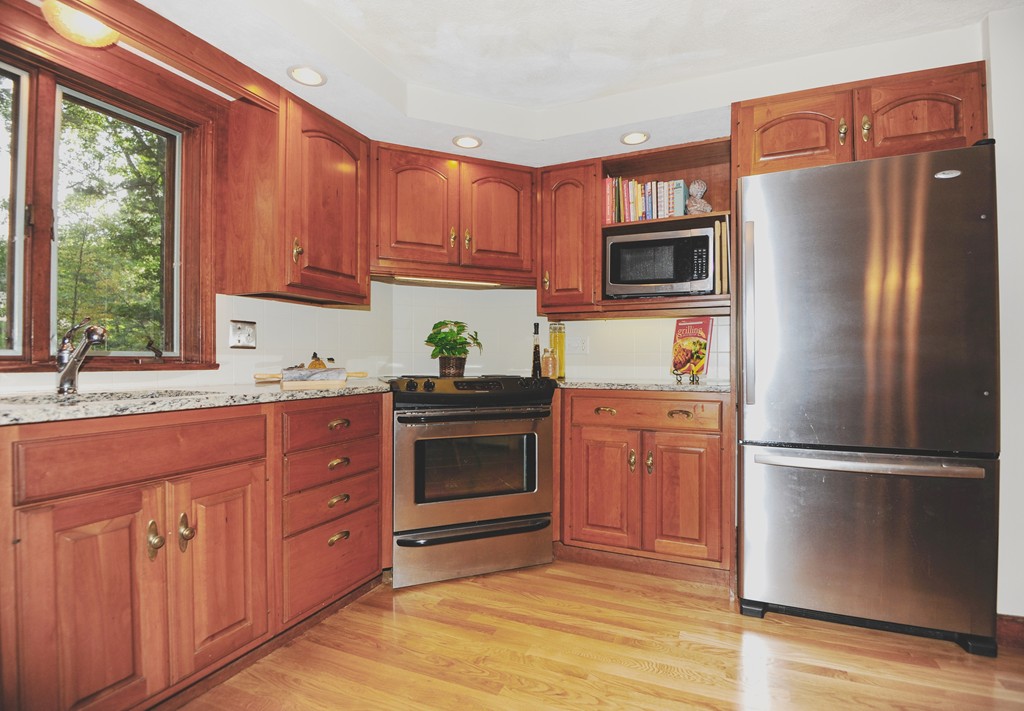 16 Olde Lantern Road Acton, MA 01720 - Photo 5 of 16 a kitchen with stainless steel appliances granite countertop a refrigerator microwave and sink
