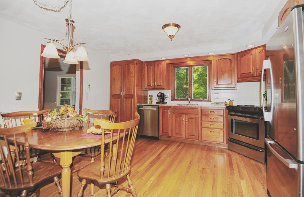 16 Olde Lantern Road Acton, MA 01720 - Photo 6 of 16 a kitchen with granite countertop a sink appliances cabinets and dining table