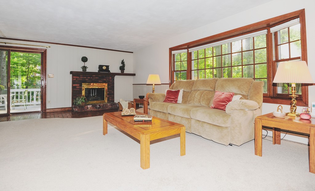 16 Olde Lantern Road Acton, MA 01720 - Photo 8 of 16 a living room with furniture and a fireplace