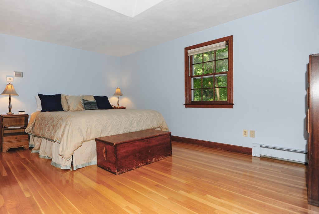 16 Olde Lantern Road Acton, MA 01720 - Photo 10 of 16 a bedroom with a bed lamp and a window