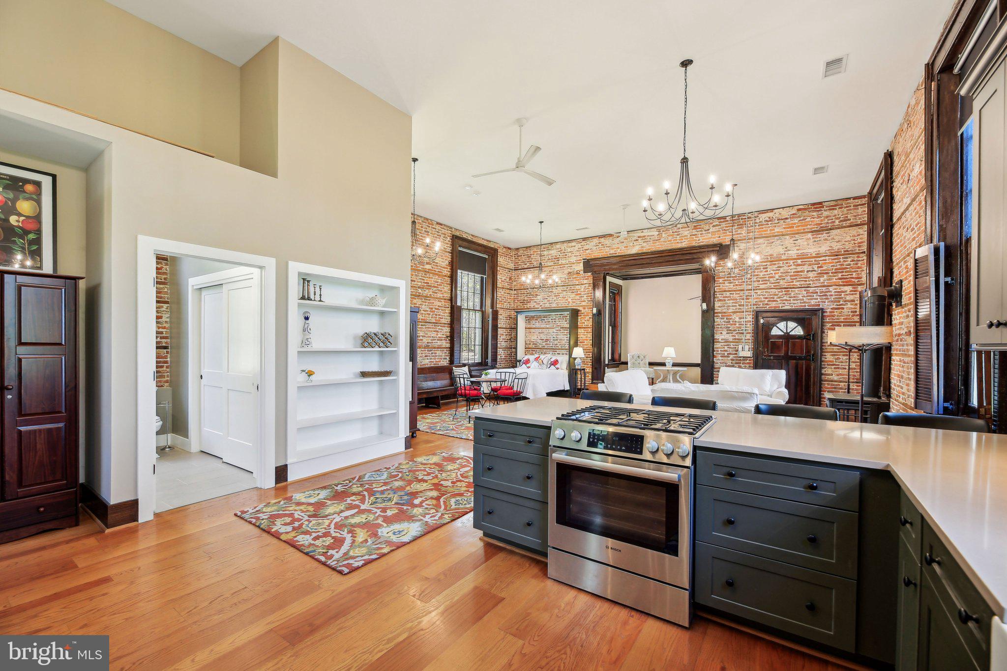 5179 Quaker Neck Road Chestertown, MD 21620 - Photo 12 of 48 a kitchen with stainless steel appliances kitchen island granite countertop a stove and a refrigerator
