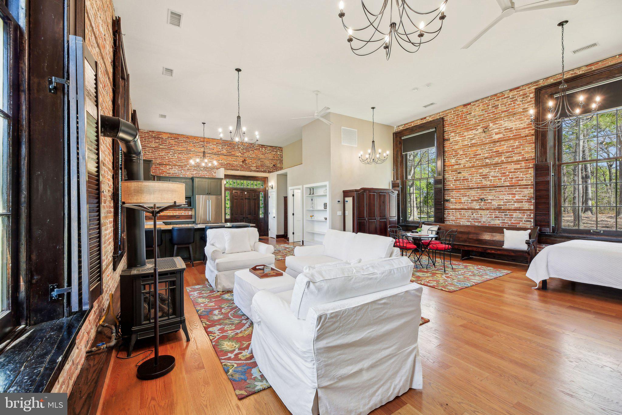 5179 Quaker Neck Road Chestertown, MD 21620 - Photo 16 of 48 a view of a dining room with furniture a chandelier and wooden floor