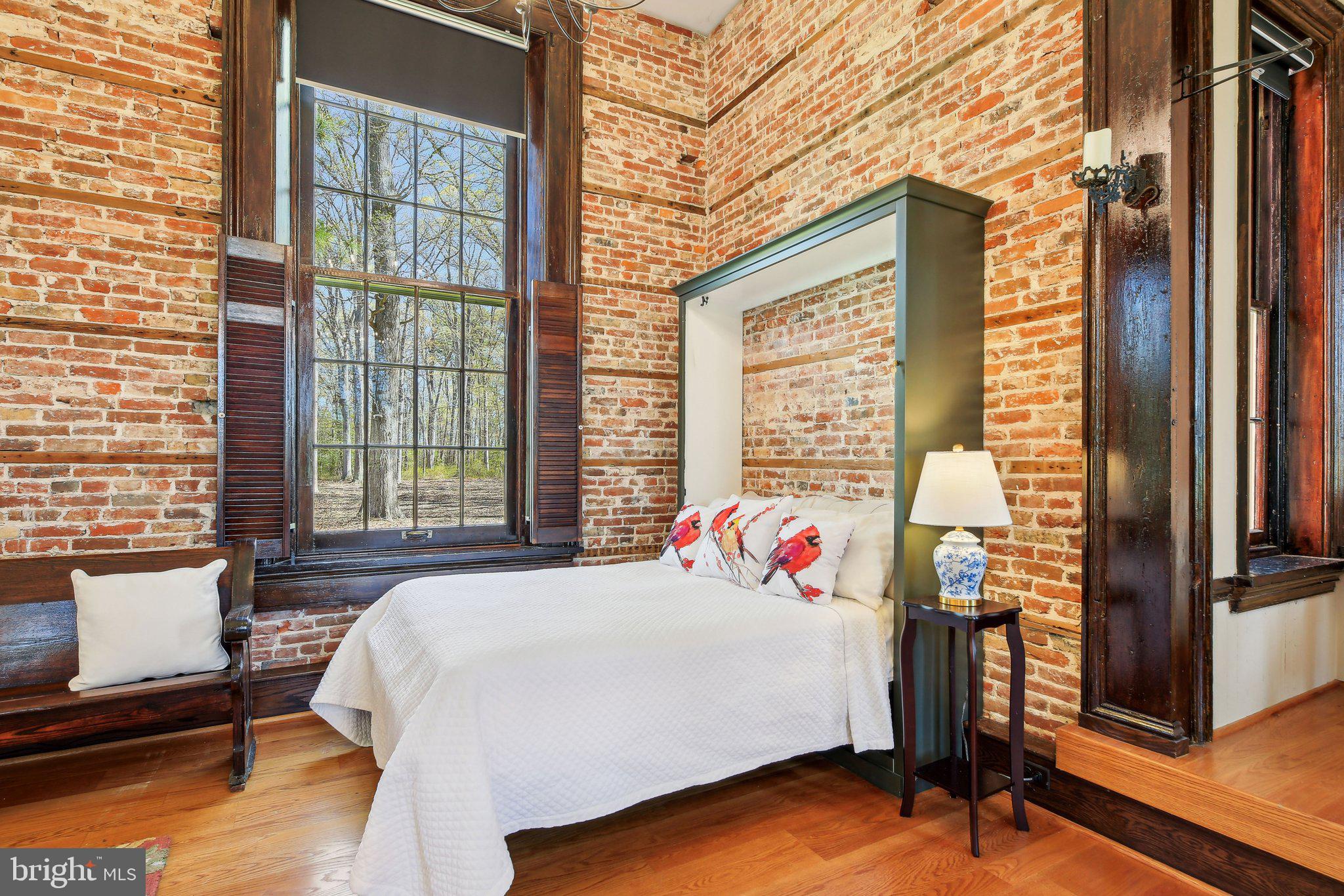 5179 Quaker Neck Road Chestertown, MD 21620 - Photo 20 of 48 a bed sitting in a bedroom next to a window