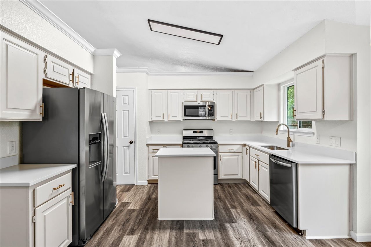 4004 Danli Lane Austin, TX 78749 - Photo 22 of 40 a kitchen with stainless steel appliances a sink cabinets and a refrigerator