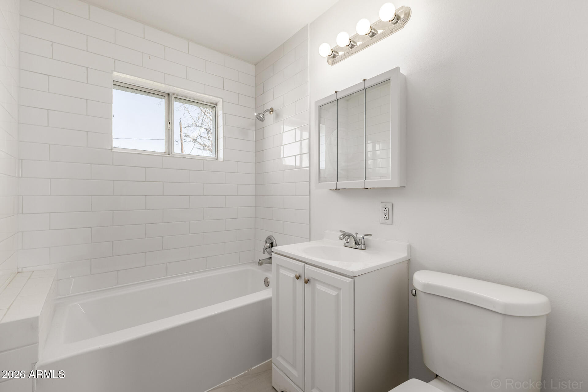 3326 West Culver Street Phoenix, AZ 85009 - Photo 14 of 18 a bathroom with a sink toilet and bathtub