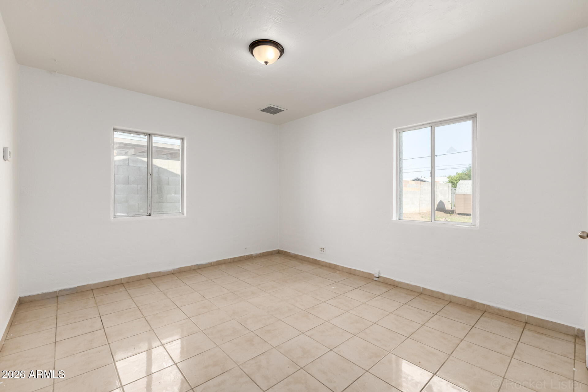 3326 West Culver Street Phoenix, AZ 85009 - Photo 15 of 18 an empty room with windows