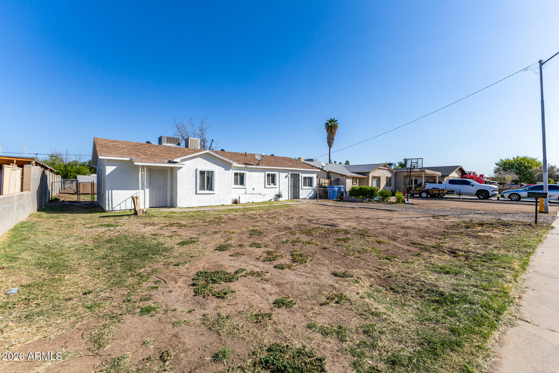 3326 West Culver Street Phoenix, AZ 85009 - Photo 2 of 18 a yellow house with trees in front of it