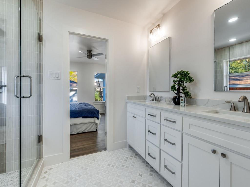 6611 Blessing Drive Dallas, TX 75214 - Photo 19 of 25 a en suite bathroom with double sink and a mirror