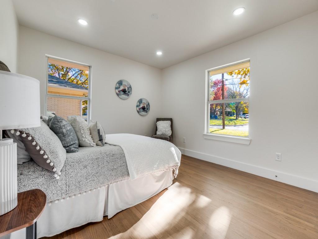 6611 Blessing Drive Dallas, TX 75214 - Photo 22 of 25 a spacious bedroom with a bed and a couch