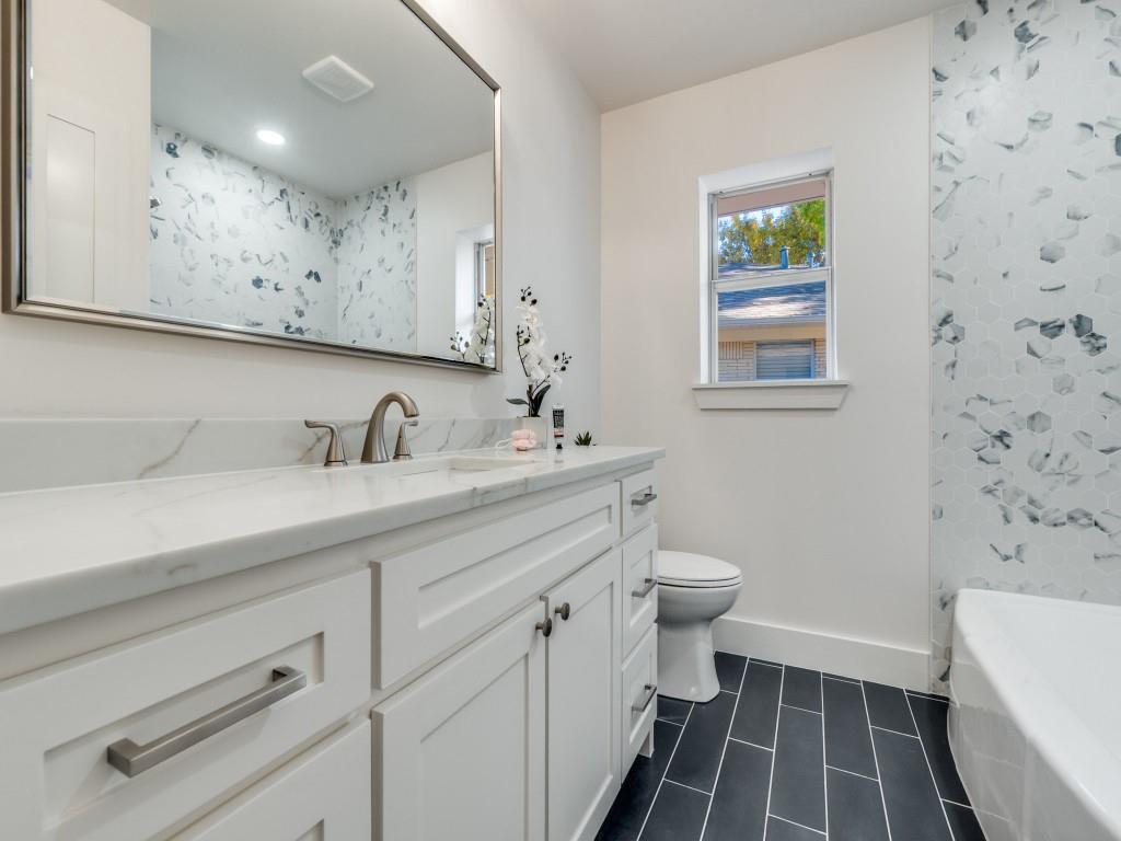 6611 Blessing Drive Dallas, TX 75214 - Photo 23 of 25 a bathroom with a sink a toilet and a mirror