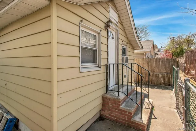 a view of a house with a wooden fence