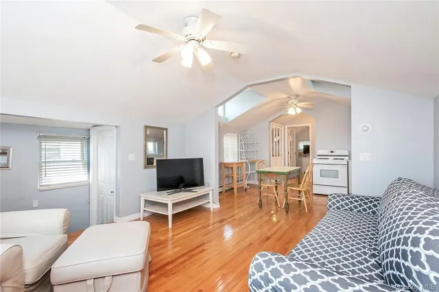 a living room with furniture a rug and a window