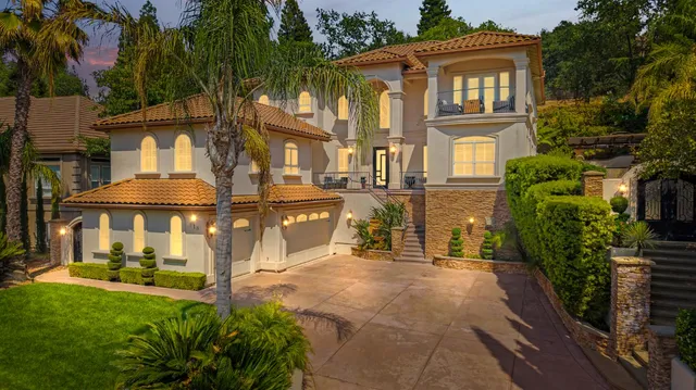 a front view of a house with a yard and a garage