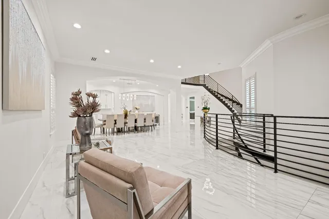 a large white kitchen with stainless steel appliances lots of counter top space