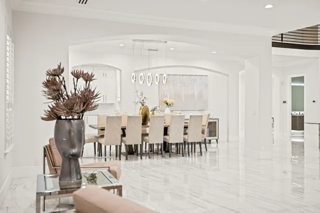 a kitchen with stainless steel appliances kitchen island granite countertop a sink a counter top space cabinets and a potted plant